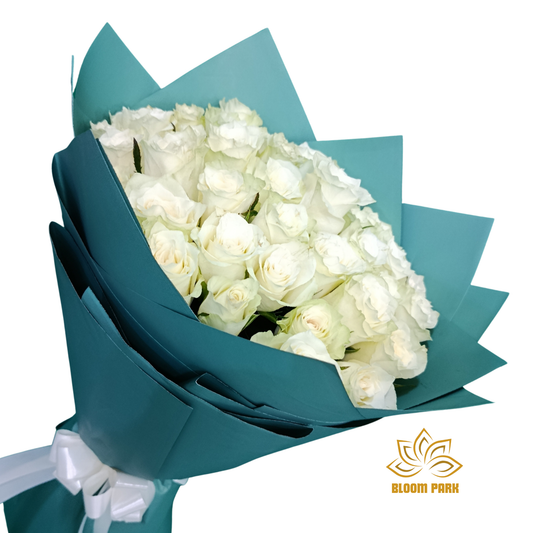 Bouquet of white roses wrapped in teal paper