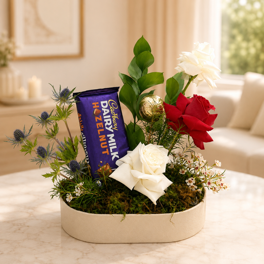Floral arrangement with a Cadbury Dairy Milk chocolate bar in a decorative setting. chocolate and flowers arrangement