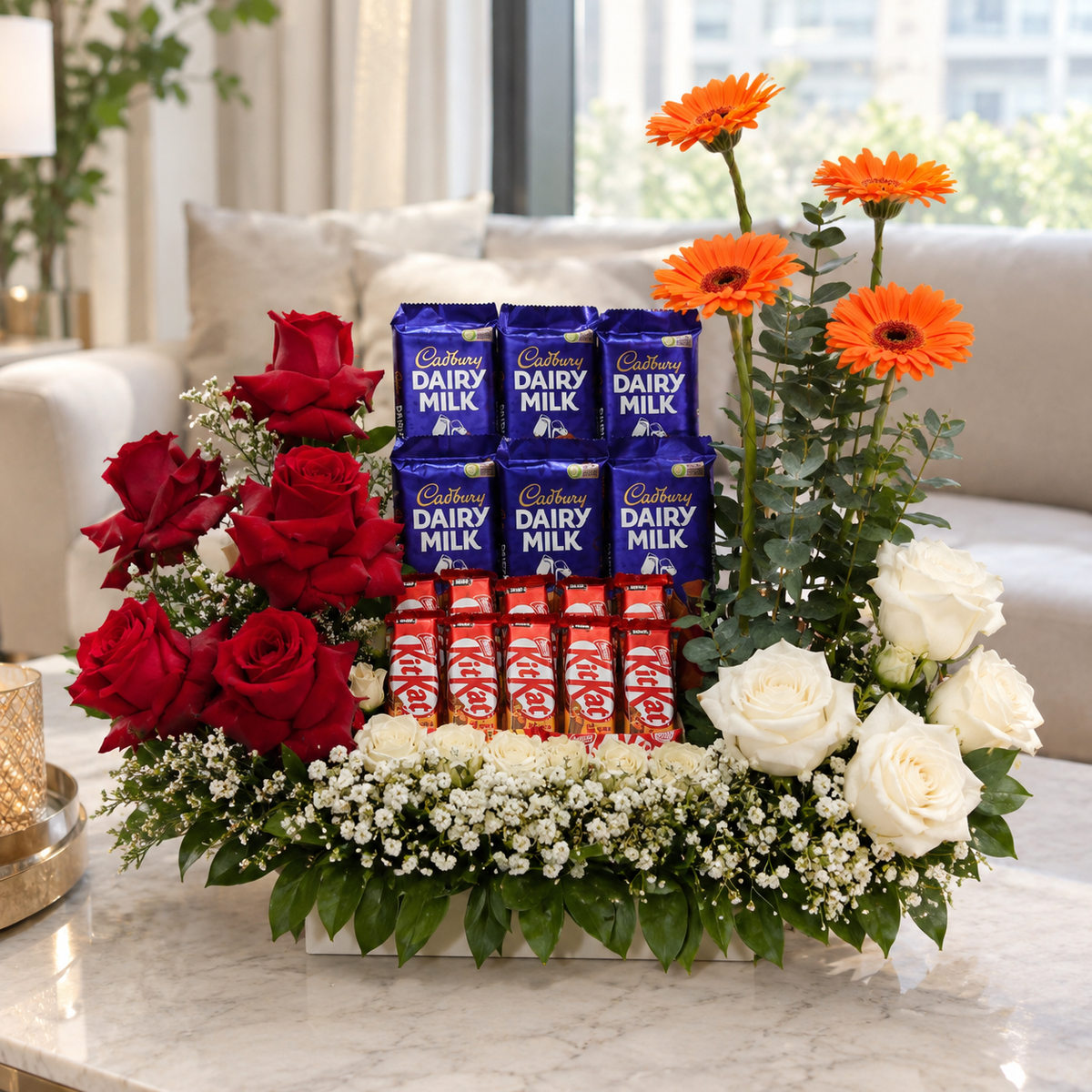 Chocolate flower arrangement with Cadbury Dairy Milk, KitKat chocolates, red roses, white roses, and orange gerberas.