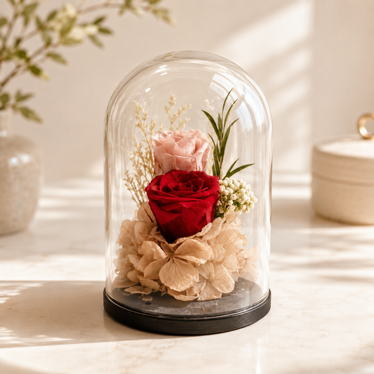 Glass dome with preserved flowers including a red rose and beige hydrangeas on a light surface, forever flowers, forever rose, flowers delivery.