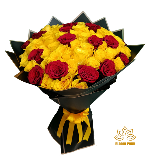 Bouquet of yellow and red roses wrapped in black paper with a yellow ribbon, red and yellow roses bouquet.
