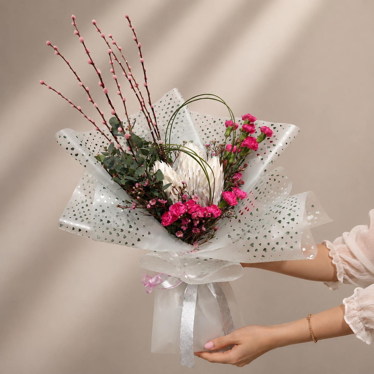 Elegant white protea and pink carnation bouquet with eucalyptus in premium white wrapping, online flowers delivery Dubai.