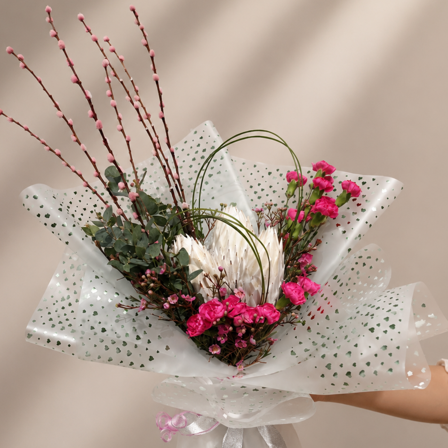 Elegant white protea and pink carnation bouquet with eucalyptus in premium white wrapping, delivery available across UAE