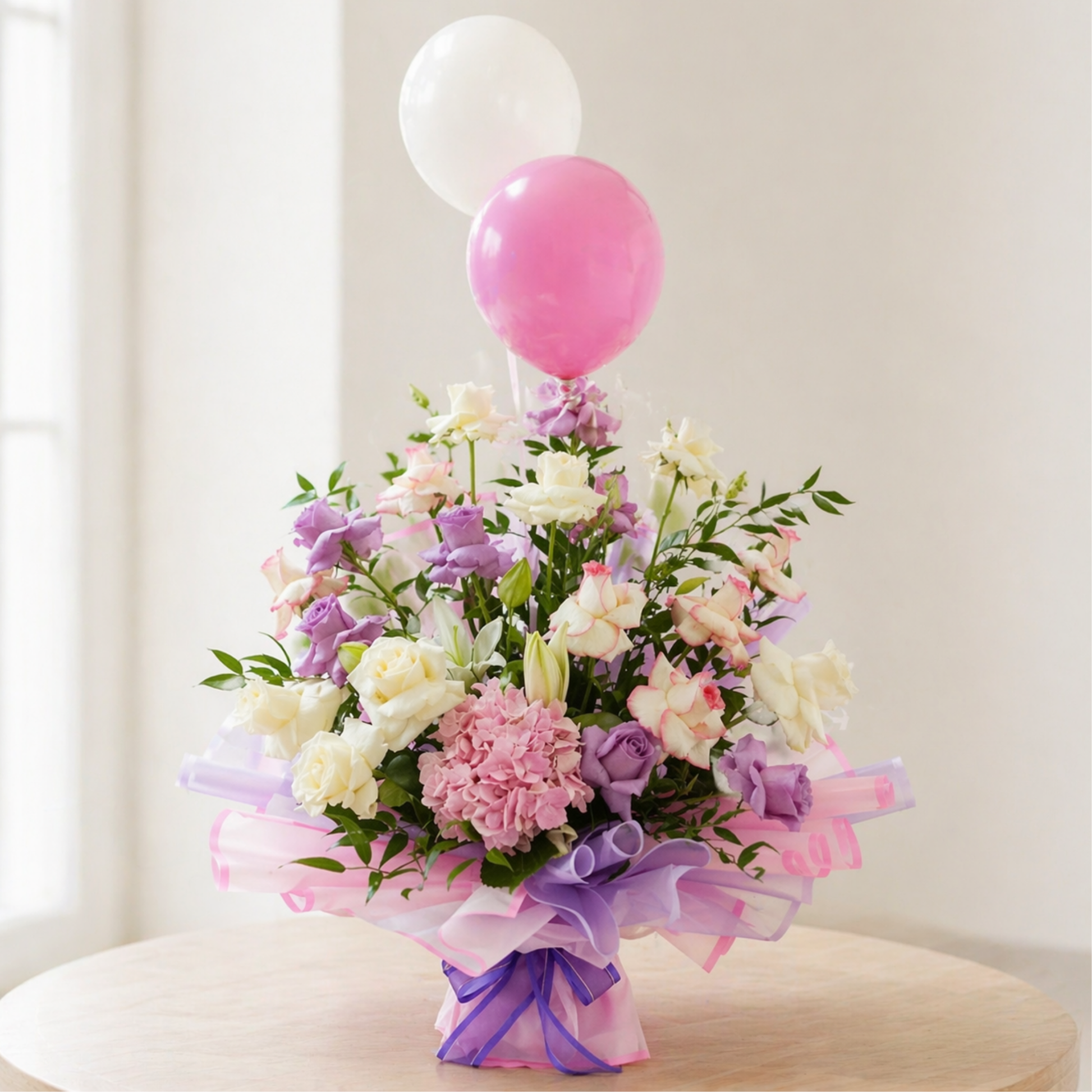 flower bouquet with pink and white roses, hydrangea, and balloons in elegant wrapping