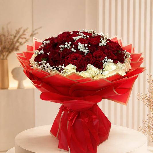 Bouquet of red and white flowers wrapped in red paper on a white surface same day delivery dubai