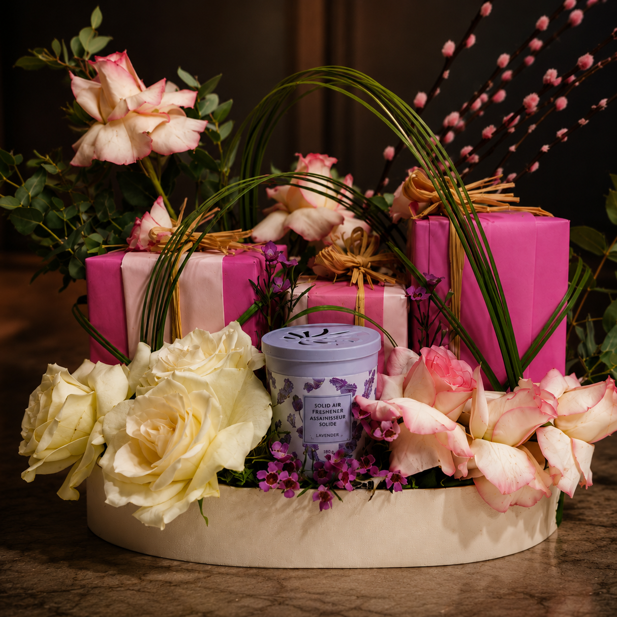 Decorative arrangement with flowers, candles, and wrapped gifts, online flowers delivery Dubai