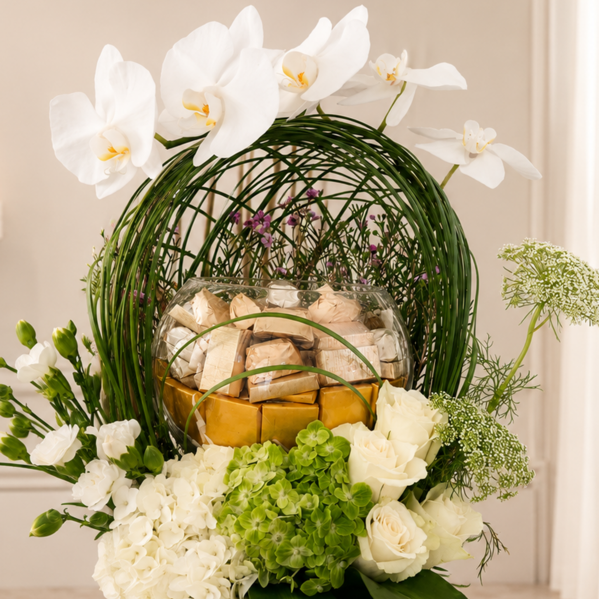 Luxury white Phalaenopsis arrangement with chocolates in a black designer vase. online flowers arrangement delivery all over UAE
