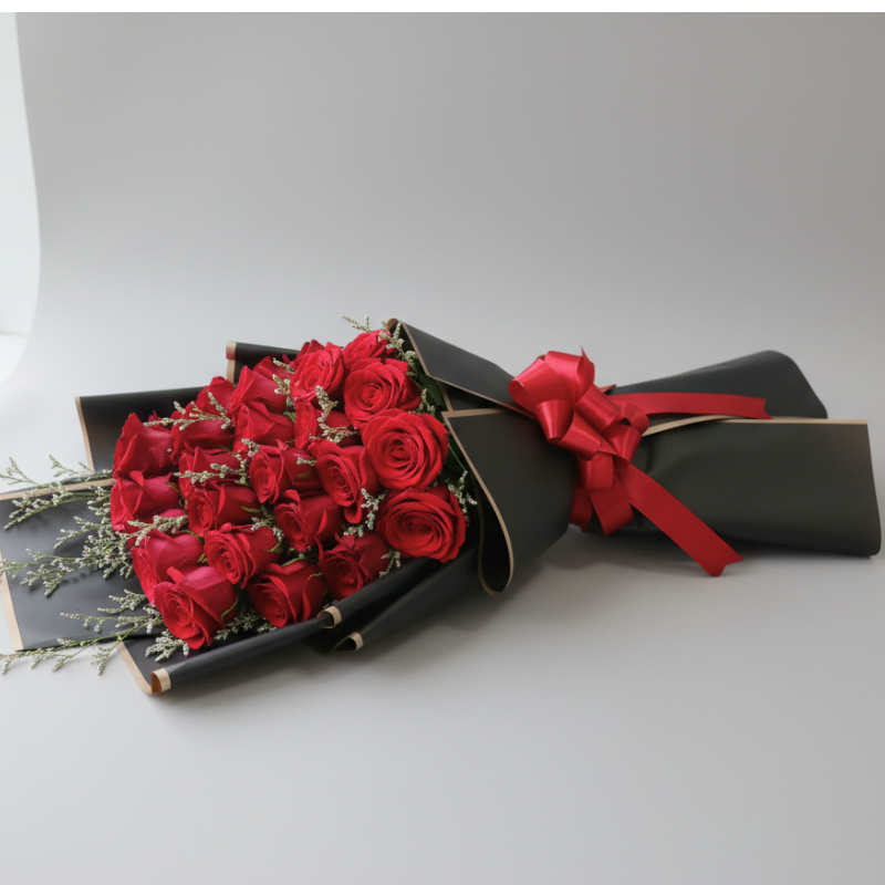 Bouquet of red roses wrapped in black paper with a red ribbon, flower delivery al rigga