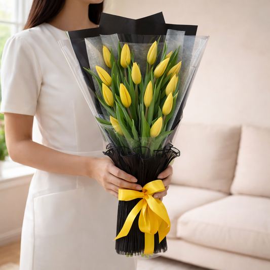 bouquet of yellow tulips wrapped in black paper with a yellow ribbon, flowers online, delivery Dubai